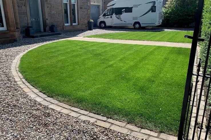A dense, striped family lawn in everyday use