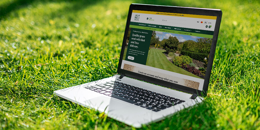 Laptop sat on grass. Grass Seed Online webpage displayed.|Grass Seed Online New Website Screenshot