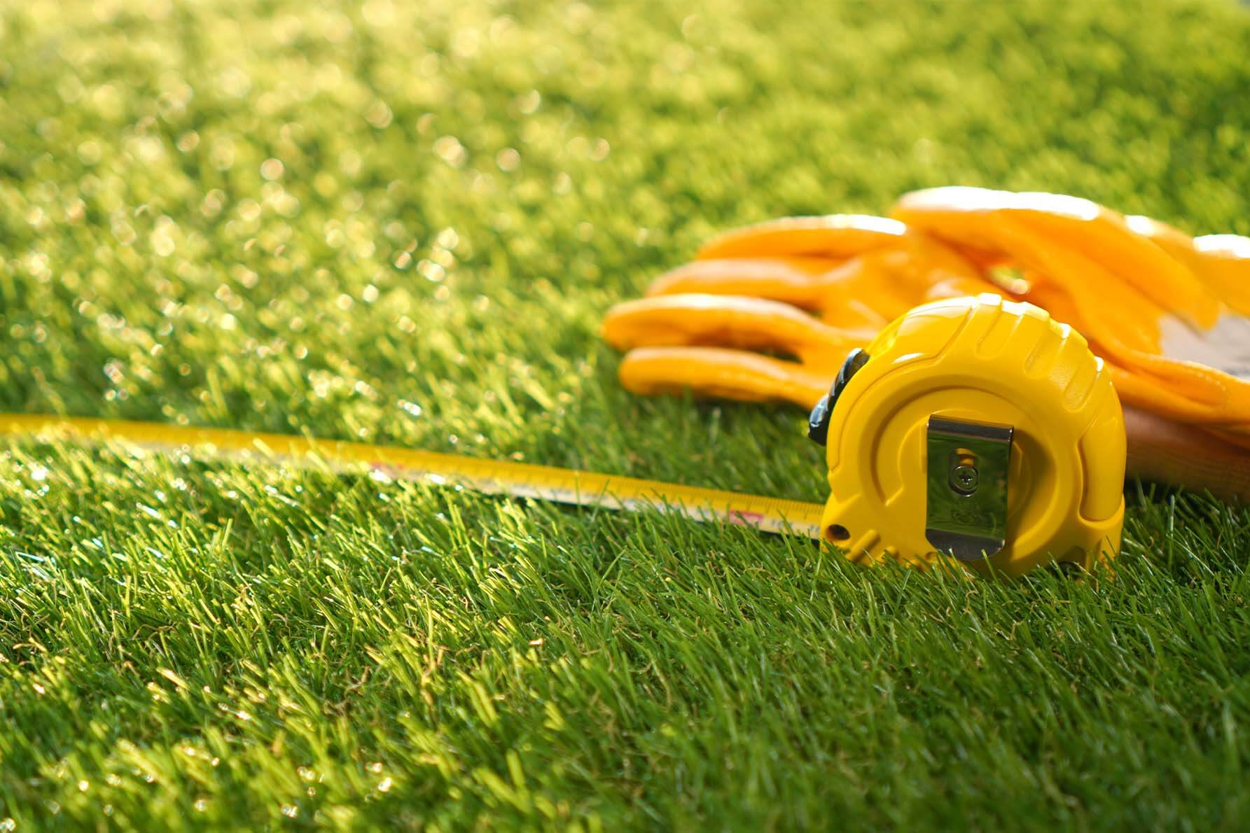 Measuring tape laying on green grass.