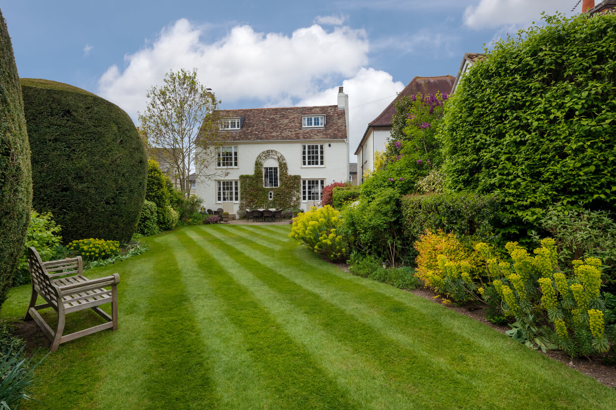 Duxford, Cambridgeshire, England - April 28 2017: Detached country cottage standing within beautiful landscaped garden.