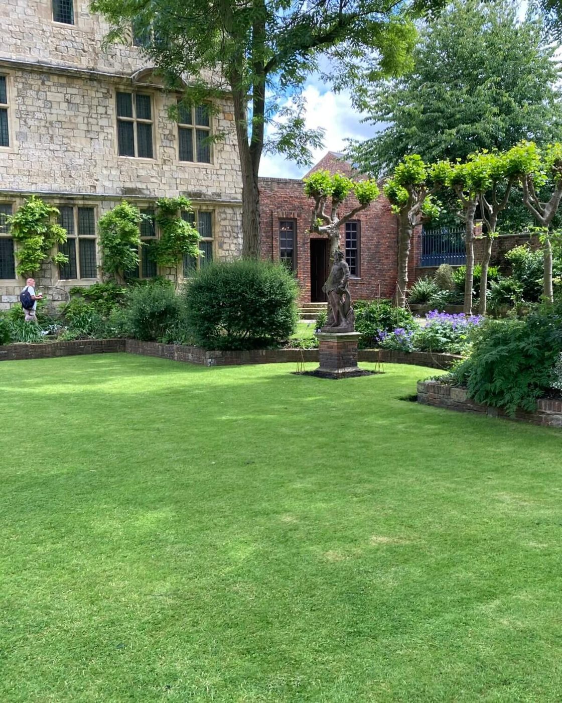 Lush lawn in a shaded walled garden